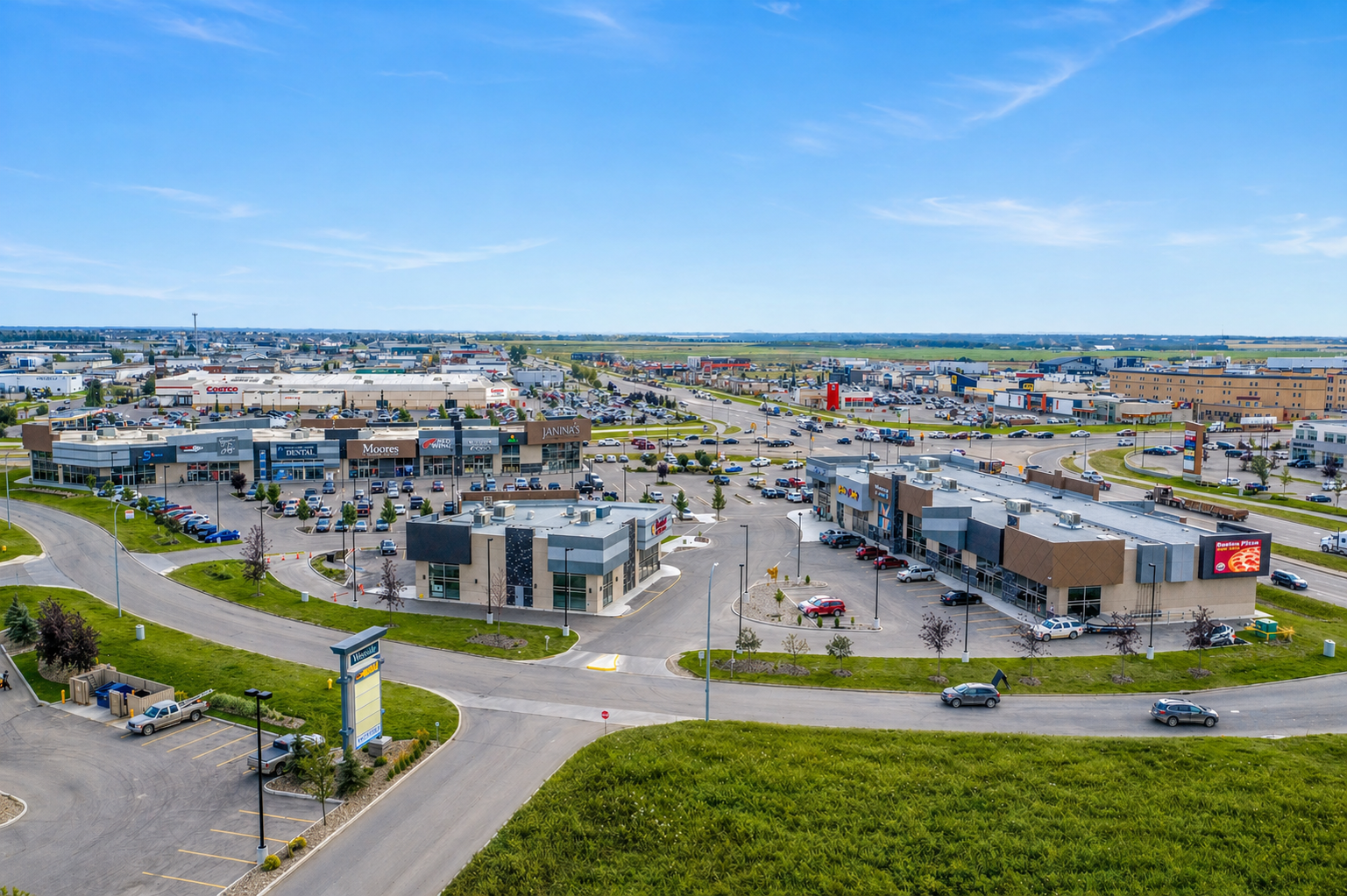 Aerial photograph of Monaco Square Retail Centre showing Janina's, Moores, Red Wing and surrounding Westgate commercial area in Grande Prairie